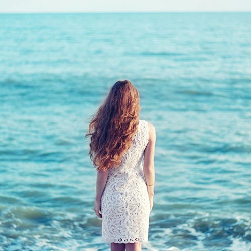 beautiful-woman-with-red-hair-at-the-sea-PTWMPAA.jpg